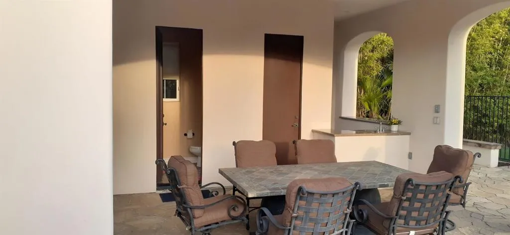 Backyard structure containing full bathroom/shower, storage room plus exterior shower on backside.
