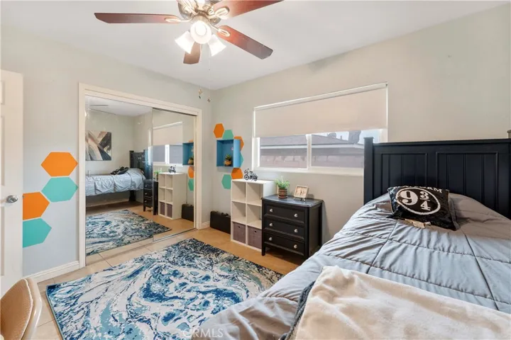 Plenty of room in this bedroom with ceiling fan and mirrored closet doors at the end of the hallway on the right side nearest the full bathroom.
