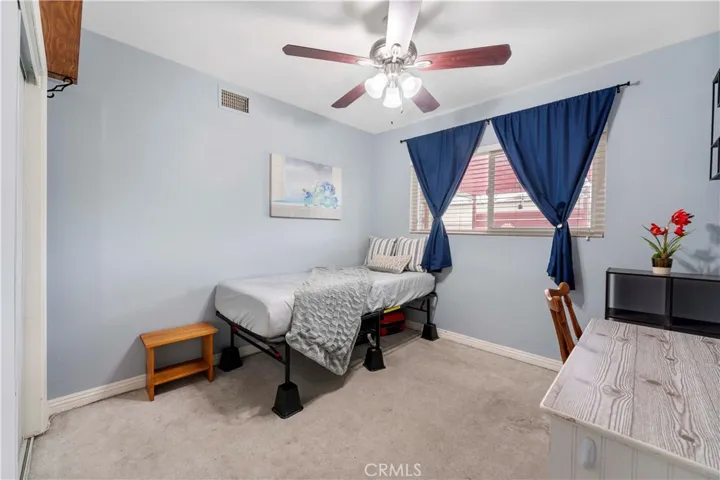 This is one of four bedrooms with ceiling fan. First one on the left side down the hallway. Window view of the backyard.
