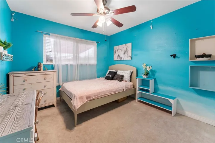 Largest of four bedrooms with ceiling fan and custom hombre paint. Window view of backyard. This room is at the end of the hallway on the left side.