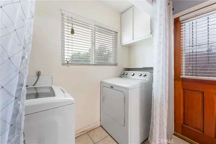 Indoor laundry at the end of the galley kitchen. Window faces the front yard. Exterior door to the side yard.