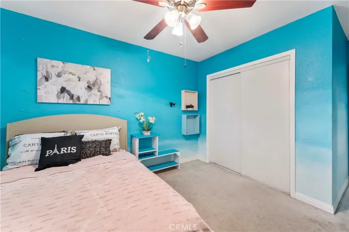 Largest of four bedrooms with ceiling fan and custom hombre paint. Window view of backyard. This room is at the end of the hallway on the left side.