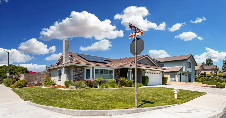Home on a corner lot with beautiful landscaping.