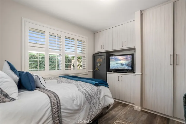 Guest Bedroom with plantation shutters and built-in cabinets.