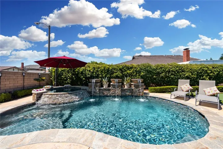 Pool with fire bowls for beauty and entertainment.