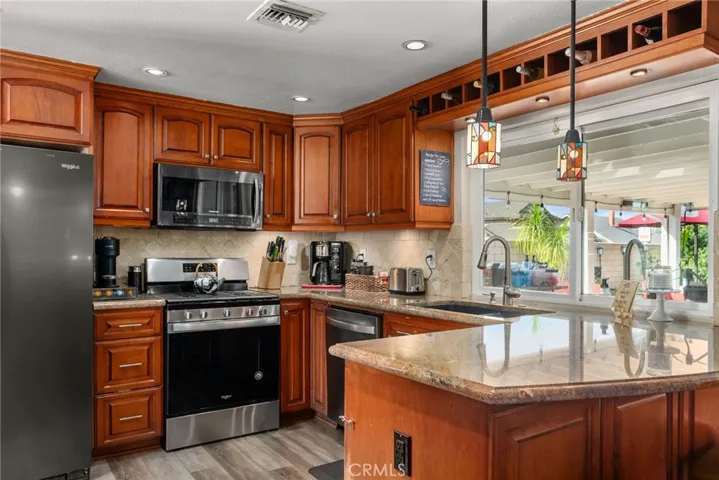 Kitchen with granite counter tops and view of the back yard.