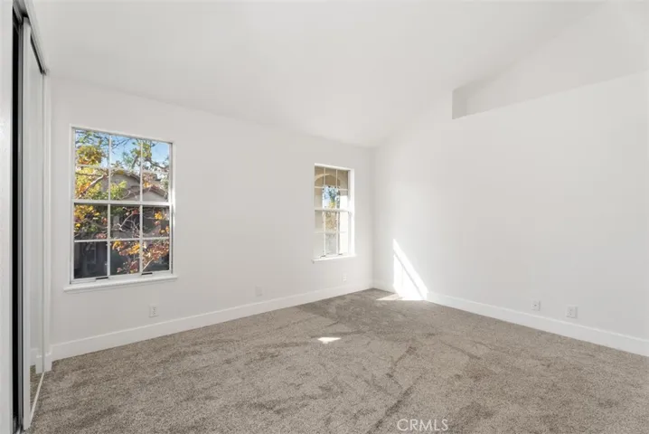 Master bedroom with high ceilings and dual window