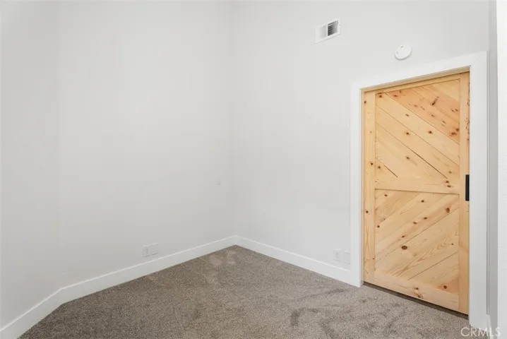 Sliding barn door was also installed in the secondary bedroom