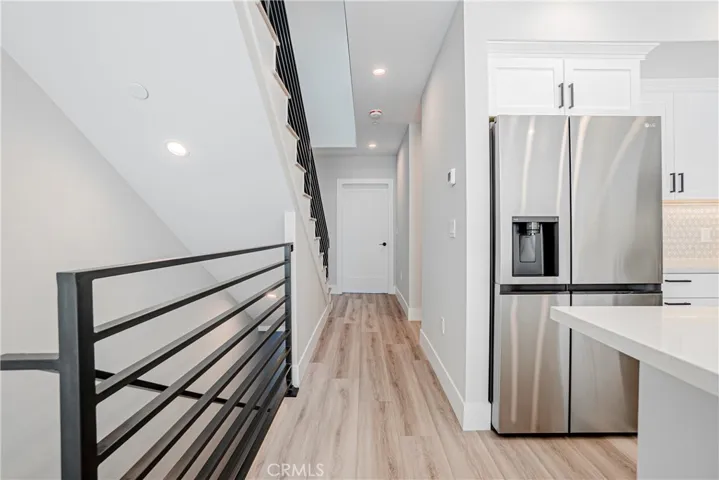 View of kitchen and hallway to main level en-suite (with door closed).