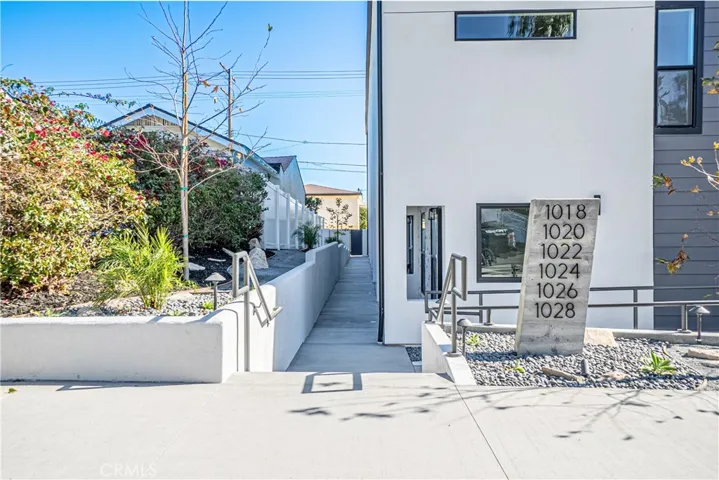 Front of Complex from Leland Street with access to front entrance. Address plaque visible.