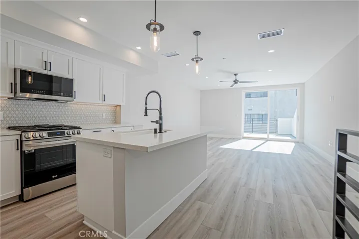 View of kitchen from main level hallway.