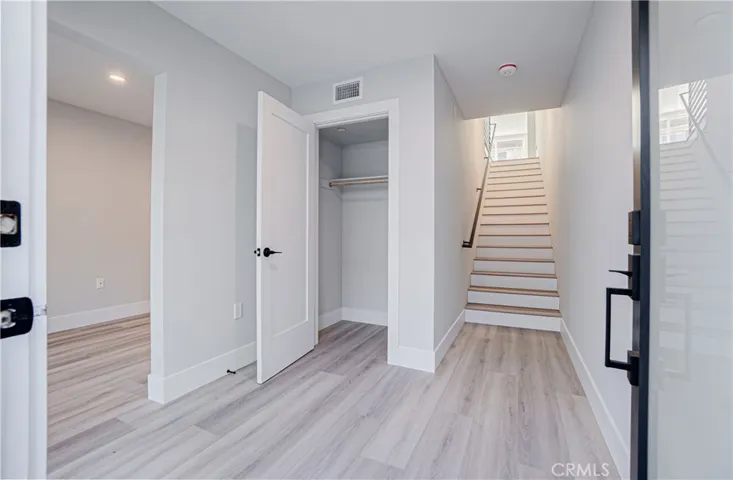 Entryway to home on ground level. Staircase leads to main living area, multi-use room and access to garage on the left.