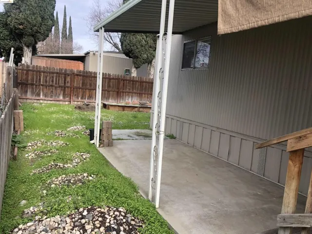 Deck side of yard. Nice concrete pad for BBQ, table and chairs for outdoor dining.
