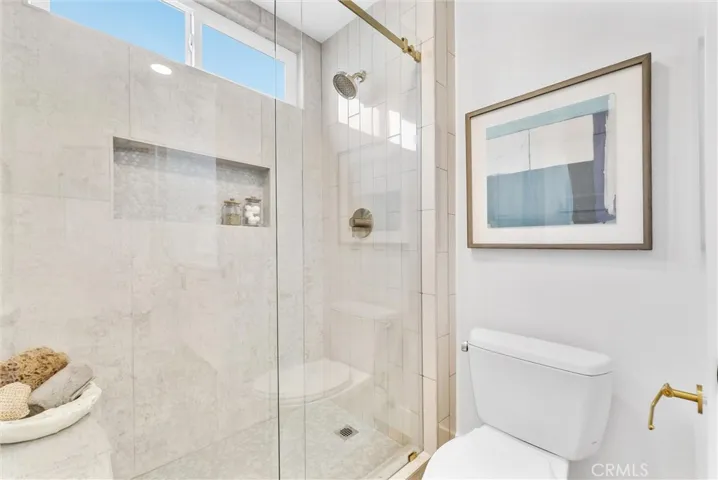 Primary bathroom with custom tile and gold highlights