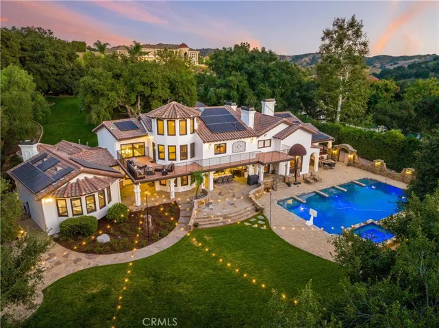Aerial image of the backyard showing the grass area, pool, and spa.