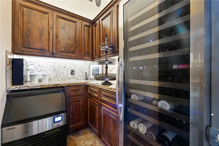 Butler's pantry in the cabana with a commercial ice maker and full size wine regrigerator.