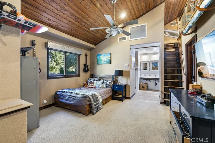 Upstairs bedroom with an additional sleeping loft and ensuite bathroom.