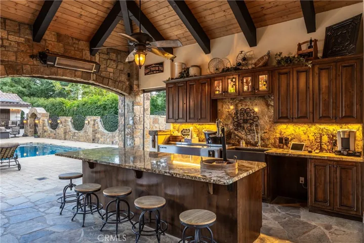 Bar with island and countertop seating and live edge finish.