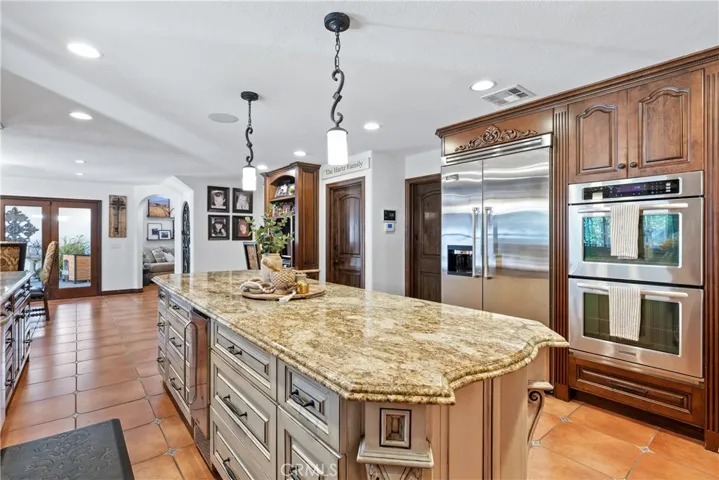 Built-in Kitchen Aid refrigerator and double ovens.