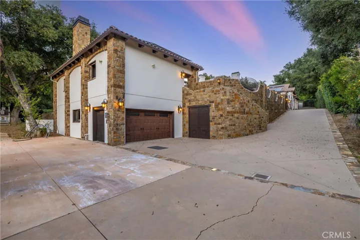 The lower part of the cabana is a four car tandem garage fully finished inside. There is also a large storage door to the right.