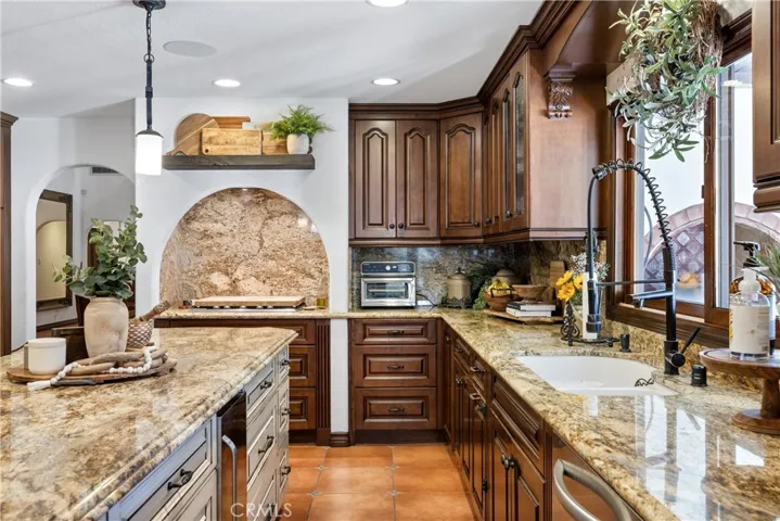 Island with a stainless steel below counter ice maker.