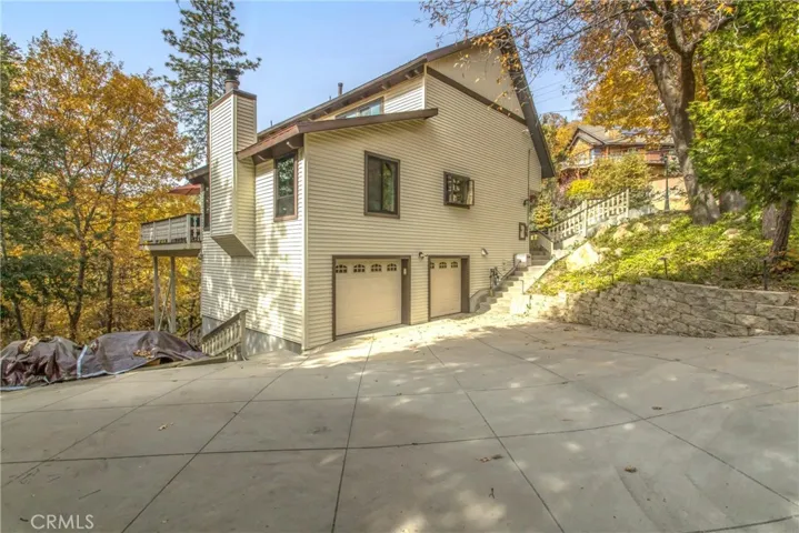 2 car garage and parking for at least 3 smaller cars.  That's a pile of wonderful wood covered over there.