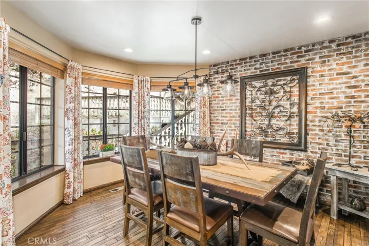 Bay window in the dining room with faux brick wall.  So charming!
