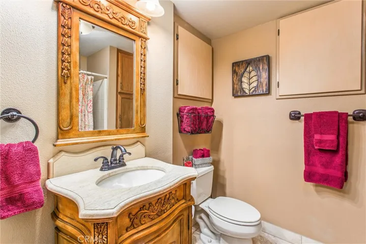 Darling bathroom with good storage behind those cupboard doors.