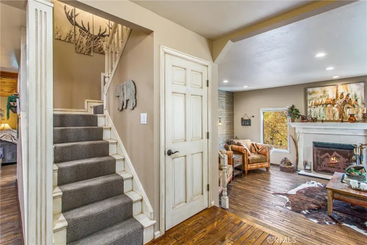 Stairs from entryway to bedrooms upstairs.