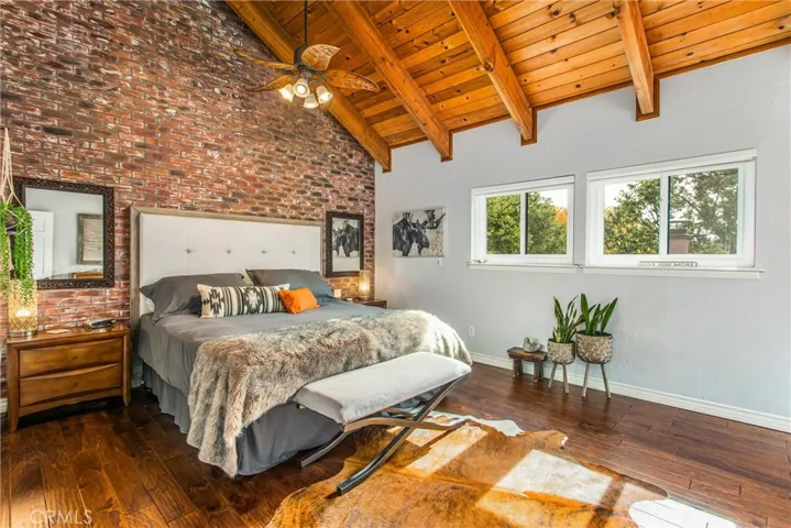 Primary bedroom has hand-painted "brick" wall