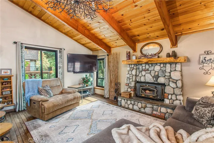 Lots of warm wood and cozy stove in river rock fireplace.