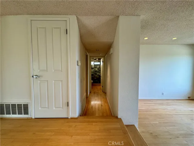 Hallway 1st floor to the 4th bedroom, garage, and full bathroom