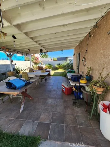 Covered patio next to garage.