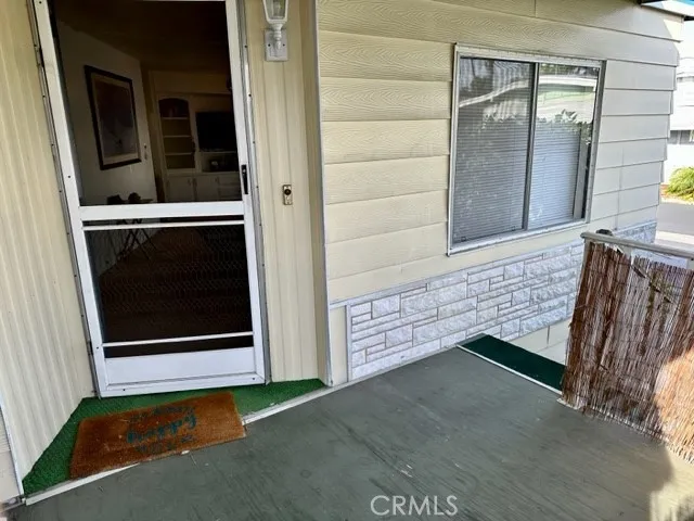 View of porch looking to the front door & steps leading up to the home
