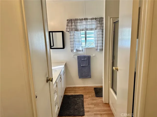 Secondary full bath with updated flooring.