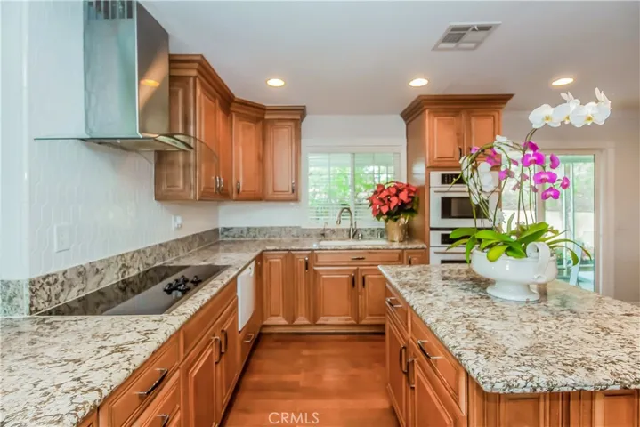 Huge Island Kitchen laminate flooring and granite countertops