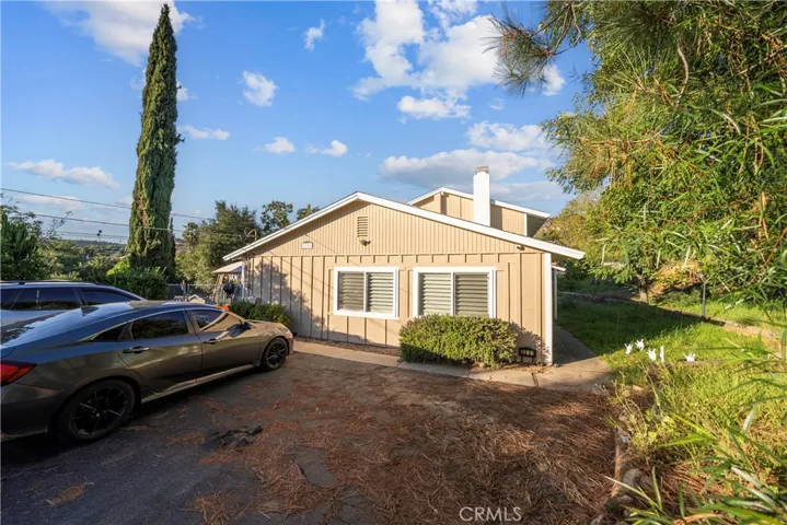 Side of the house that has a driveway for 4 cars