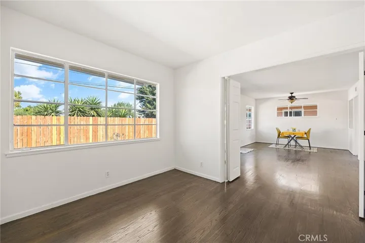 View of bedroom #1 with double doors opening to the living room.
