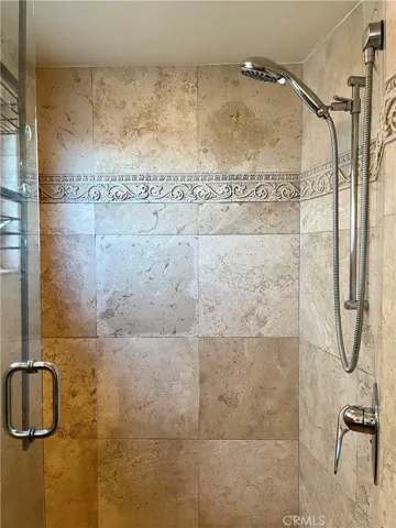 Downstairs Bathroom with standing shower and stone tiles