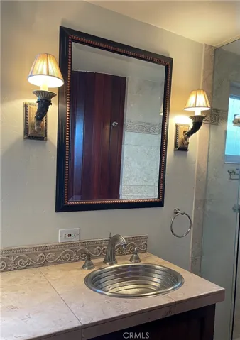 Downstairs Bathroom with standing shower and stone tiles