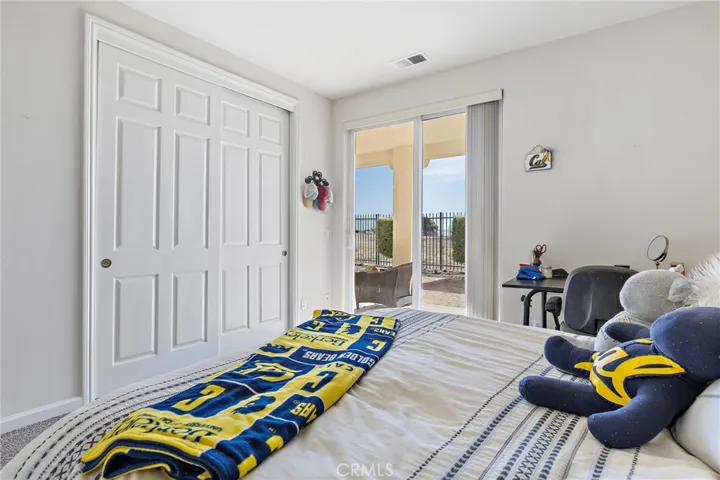 Guest bedroom looking out towards sliding glass door to patio