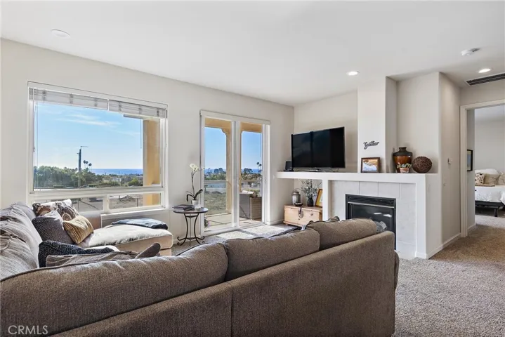 Living room looking out picture window and sliding glass door at the panoramic view of the ocean