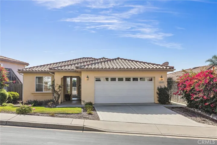 Front of home with two car garage and ample driveway parking