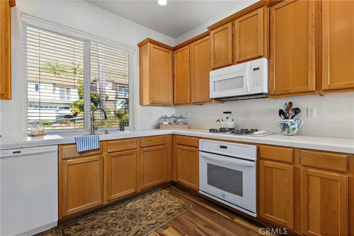 Updated Kitchen with cooktop, gas oven, and mirowave/hood