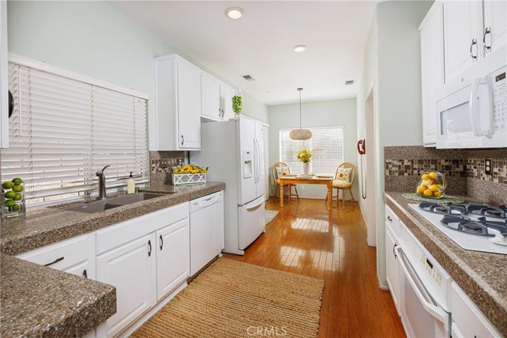 Kitchen offers beautiful wood flooring and granite countertops