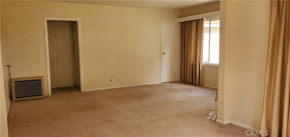 View of the Living Room from the Dining Room (floor furnace)
