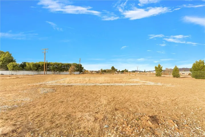 Large open area with double drive through gates for storage, parking, or further development. This property is zoned for horses - buyer to verify with the Town of Apple Valley.