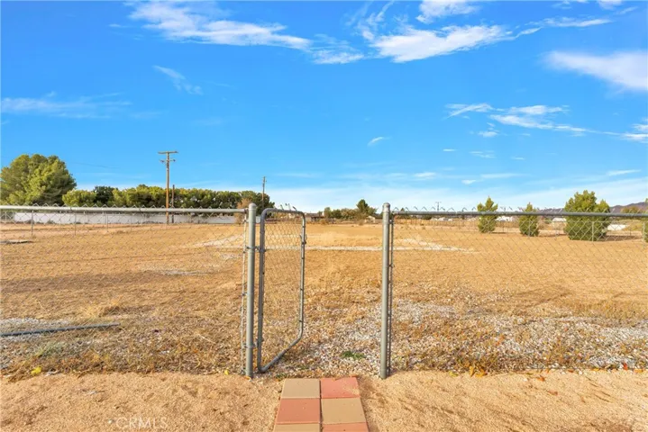 Gate leading from primary back yard area to the undeveloped large rear portion of the property.