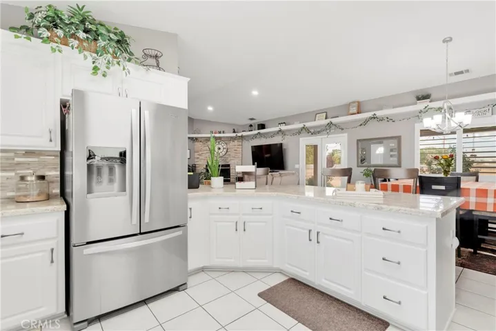 Kitchen features extra deep drawers, custom pots and pans pull out shelves on either side of the stove and a tall cabinet ideal for cookie sheets.