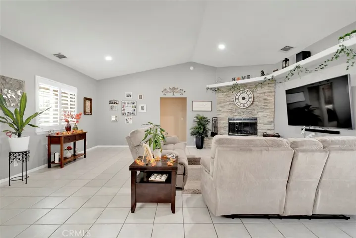 Open floor plan with tile flooring, crisp neutral paint and many custom home features.